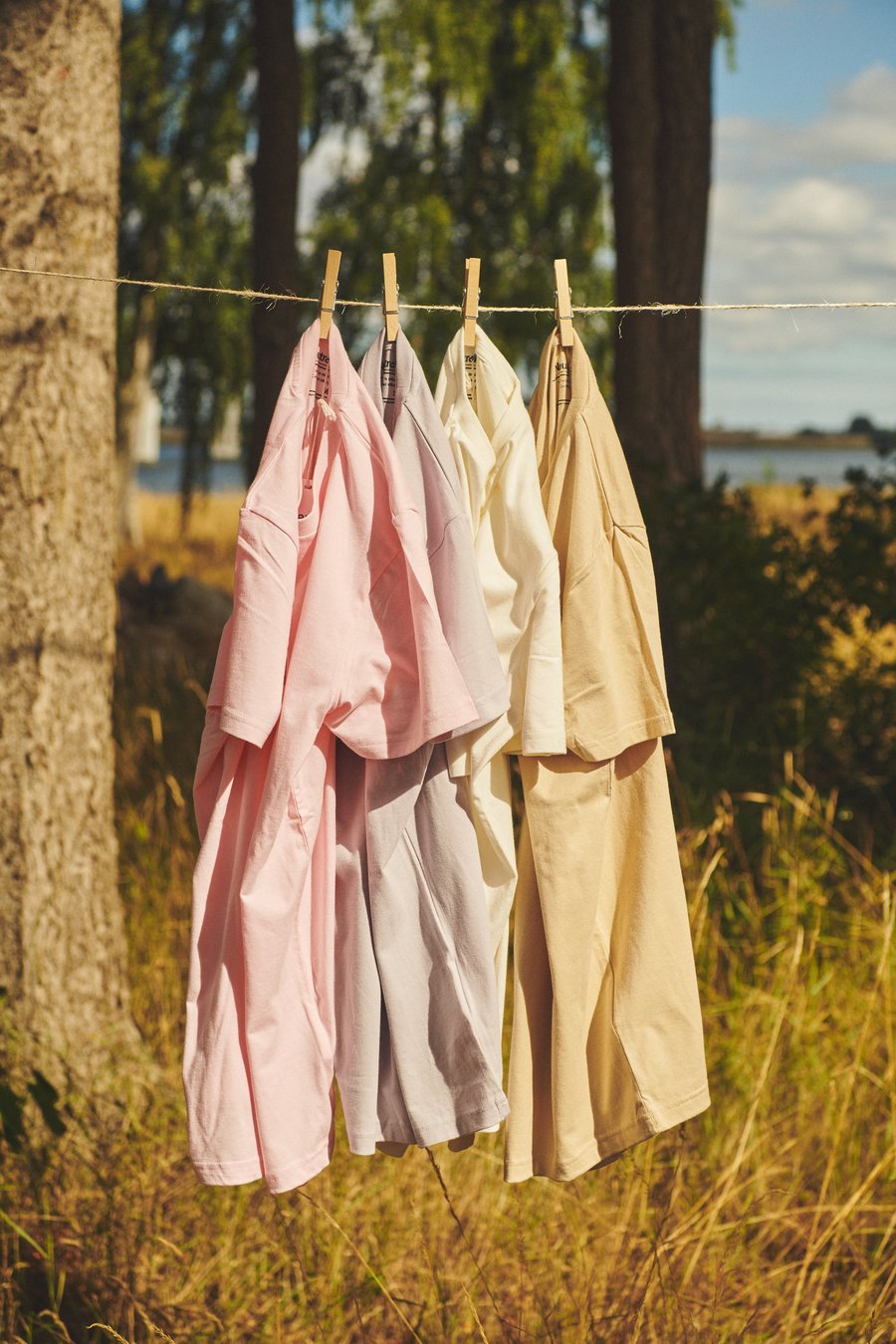 T-Shirts aus Bio-Baumwolle in Pastelltönen auf Wäscheleine